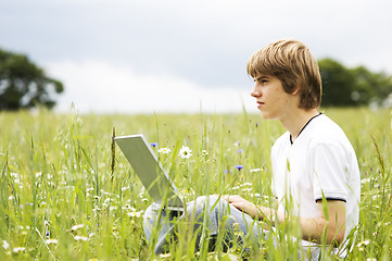 Image showing Boy with notebook on the field