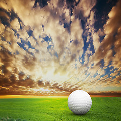 Image showing Playing golf. Ball on golf field at sunset