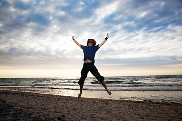 Image showing Happy young man jumping