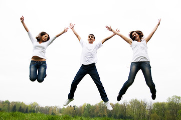 Image showing Happy friends jumping