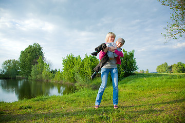 Image showing Young mother playing with her child 