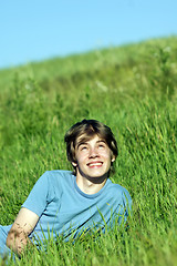 Image showing Boy lying on the fresh green grass