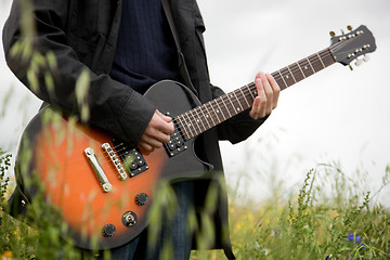 Image showing Close up of a man playing guitar