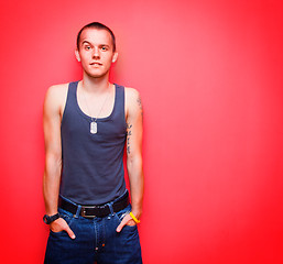 Image showing Young handsome man on red wall