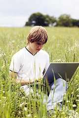 Image showing Boy with notebook on the field