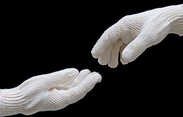 Image showing Labor's hands in safety gloves conection. isolated on black