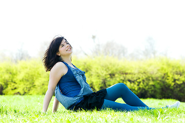 Image showing Young happy girl lying on grass