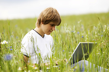 Image showing Boy with notebook on the field