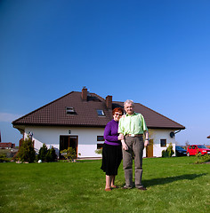 Image showing Senior couple in front of the house