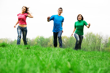 Image showing Happy friends jumping