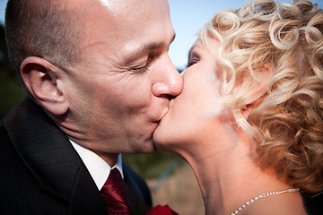 Image showing Happy bride and groom kissing