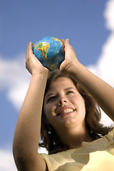 Image showing Pretty girl watching earth globe