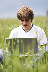 Image showing Boy with notebook on the field