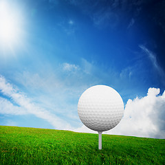 Image showing Playing golf. Ball on tee on green golf field