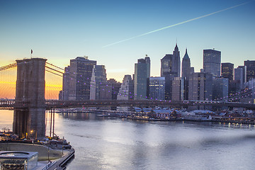 Image showing Lights of New York City and Brooklyn Bridge at Sunset