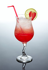 Image showing glass of red cocktail with strawberry decor