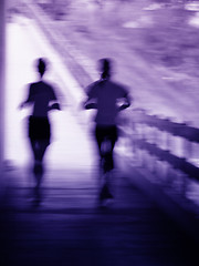 Image showing Artistic blur of a running couple