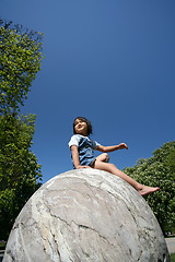 Image showing Child on a spherical rock