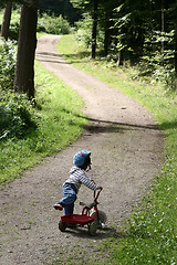 Image showing child playing with her cycle