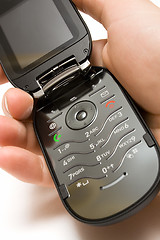 Image showing Holding an Open Cell Phone