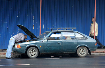 Image showing Man checking his car in Russia