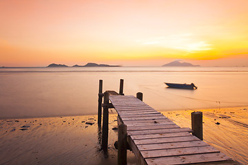 Image showing Sunset pier along coast