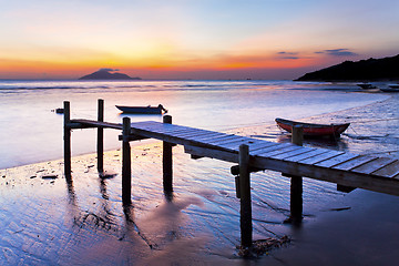 Image showing Sunset coast at wooden pier