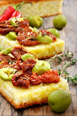 Image showing Bread with olive oil with sun-dried tomatoes and thyme. 