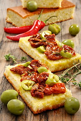 Image showing Appetizer of sun-dried tomatoes, olives and thyme.