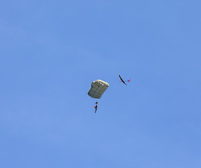 Image showing RC glider flies around jumper