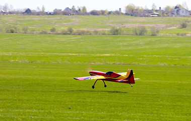 Image showing RC model airplane lands on the grass