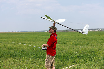 Image showing Man launches into the sky RC glider