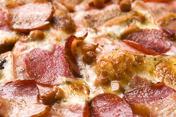 Image showing Italian pizza with bacon, salami and mozzarella cheese