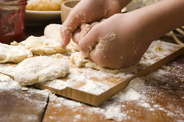Image showing Detail of hands kneading dough
