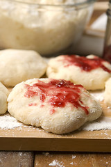 Image showing Dough with marmelade on wooden board