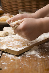 Image showing Detail of hands kneading dough