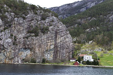 Image showing some houses under big rock