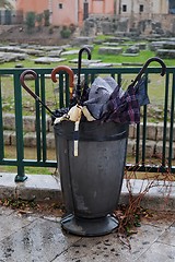 Image showing Trash bin full of broken umbrellas