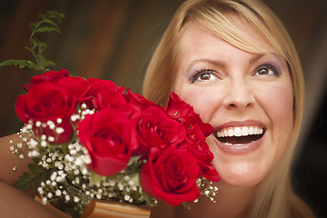 Image showing Smiling Blonde Woman with Red Roses