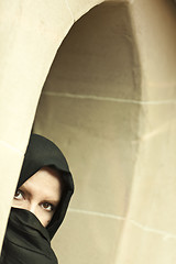 Image showing Cautious Islamic Woman in Window Pane Wearing Burqa or Niqab