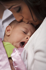 Image showing Attractive Ethnic Woman with Her Yawning Newborn Baby