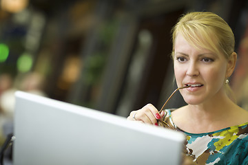 Image showing Beautiful Blonde Woman On Her Cell Phone and Laptop Computer in 