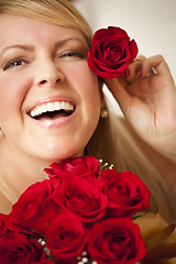 Image showing Woman with a Bunch of Red Roses.