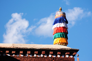 Image showing Colorful prayer flags on the roof