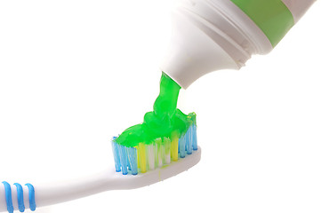 Image showing Toothpaste coming out of a tube on Toothbrush on white background