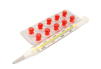 Image showing Pills Vitamin E capsules and thermometer on white background