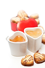 Image showing heart shaped cream cookies on red heart metal box and coffee