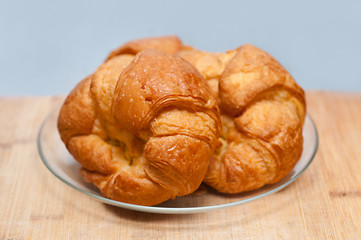 Image showing fresh baked french croissant brioche on wood board