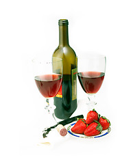 Image showing red wine bottle and two glasses with strawberries