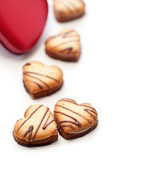 Image showing heart shaped cream cookies on red heart metal box